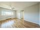 Bright living room with hardwood floors, a ceiling fan, and a large window offering lots of natural light at 2100 N Franklin St # 8, Denver, CO 80205
