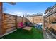 Outdoor seating with backyard artificial turf and wood fence at 3835 N Raleigh St, Denver, CO 80212