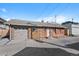 Brick home featuring a garage, brick and shingle siding and a well-maintained yard with nice stonework at 3835 N Raleigh St, Denver, CO 80212