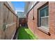 Cozy side yard featuring artificial turf, a privacy fence, and access gate for outdoor enjoyment at 3835 N Raleigh St, Denver, CO 80212