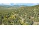 Breathtaking landscape with winding roads leading to homes nestled among the lush trees at 25728 Stanley Park Rd, Evergreen, CO 80439