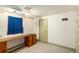 Finished basement space featuring a built-in desk, a window, and a closet at 25728 Stanley Park Rd, Evergreen, CO 80439