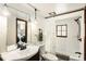 Bathroom showcasing a vanity, toilet, shower, and view into a laundry room at 25728 Stanley Park Rd, Evergreen, CO 80439