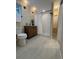 Modern bathroom features a tiled walk-in shower, wood vanity and updated fixtures at 25728 Stanley Park Rd, Evergreen, CO 80439