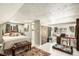 Bright bedroom with a bed, workspace, ensuite and unique design details throughout at 25728 Stanley Park Rd, Evergreen, CO 80439