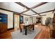 Elegant dining room with coffered ceilings, hardwood floors, and access to a fireplace at 25728 Stanley Park Rd, Evergreen, CO 80439