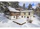 Exterior log cabin home featuring a snow-covered patio at 25728 Stanley Park Rd, Evergreen, CO 80439
