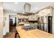 Well-equipped kitchen features custom cabinets, butcher block countertops, and modern appliances at 25728 Stanley Park Rd, Evergreen, CO 80439