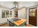 The kitchen features a center island, gas cooktop, and an exterior door at 25728 Stanley Park Rd, Evergreen, CO 80439
