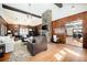 Spacious living room with hardwood floors, a stone fireplace, and exposed beam ceilings at 25728 Stanley Park Rd, Evergreen, CO 80439