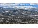 Expansive mountain view showcasing snow-covered terrain and dense evergreen forests at 25728 Stanley Park Rd, Evergreen, CO 80439