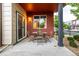 Cozy back patio with a wooden table and chairs and beautiful landscaping at 2110 W 67Th Pl, Denver, CO 80221