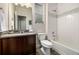 Modern bathroom featuring a vanity with countertop sink, toilet, and shower-tub combination with tile surround at 2110 W 67Th Pl, Denver, CO 80221