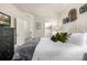 Comfortable bedroom with decorative wall accents, leading to the ensuite bathroom and walk-in closet at 2110 W 67Th Pl, Denver, CO 80221