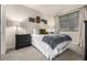 Comfortable bedroom with large window, decorative accents, and two dark-wood nightstands at 2110 W 67Th Pl, Denver, CO 80221