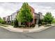 Street view featuring a colorful array of modern townhomes and lush greenery at 2110 W 67Th Pl, Denver, CO 80221