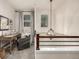 Upstairs hallway with desk area and wood railing at 2110 W 67Th Pl, Denver, CO 80221