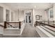 Upstairs hallway with wood and metal railing, leading to bedrooms and living spaces at 2110 W 67Th Pl, Denver, CO 80221