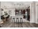 Open concept kitchen with granite island, stainless steel appliances, and seamlessly connects to dining area at 2110 W 67Th Pl, Denver, CO 80221