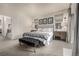 Bright main bedroom with a tufted headboard, decorative wall art, bedside tables, and plush carpeting at 2110 W 67Th Pl, Denver, CO 80221