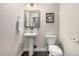 Powder room featuring pedestal sink, modern fixtures and wood look flooring at 2110 W 67Th Pl, Denver, CO 80221