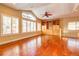 Bright living room with hardwood floors, built-in shelves, fan, tray ceiling, and lots of natural light at 5255 Ridge Trl, Littleton, CO 80123