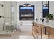 Spa-like bathroom with soaking tub, glass shower, and modern vanity at 410 S Vine St, Denver, CO 80209