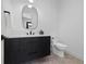 Contemporary powder room with floating vanity and oval mirror at 410 S Vine St, Denver, CO 80209