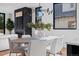 Modern dining area with oval table, white chairs, and a stylish chandelier at 410 S Vine St, Denver, CO 80209