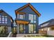 Stylish two-story home with a combination of brick and dark wood siding at 410 S Vine St, Denver, CO 80209