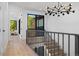 Modern hallway with stylish metal railing and hardwood floors at 410 S Vine St, Denver, CO 80209