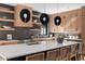 Stylish kitchen features light wood cabinets, a large island, and floating shelves at 410 S Vine St, Denver, CO 80209