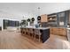 Modern kitchen with island, stainless steel appliances, and light hardwood floors at 410 S Vine St, Denver, CO 80209