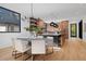 Open concept kitchen with island and dining area, featuring hardwood floors at 410 S Vine St, Denver, CO 80209