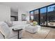 Spacious living room with sectional sofa, ottoman, and large windows at 410 S Vine St, Denver, CO 80209