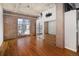 Bedroom features hardwood floors, exposed ductwork, a mirrored closet, a large window, and concrete pillars at 2020 Arapahoe St # 1130, Denver, CO 80205