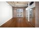 Bedroom with hardwood floors, exposed ductwork and a large window showing a skyline view at 2020 Arapahoe St # 1130, Denver, CO 80205