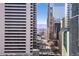 Daytime city view of a busy downtown corridor with surrounding buildings, mountains, and skyscrapers at 2020 Arapahoe St # 1130, Denver, CO 80205