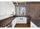 Well-lit kitchen with stainless steel appliances, sleek countertops, white cabinetry, and stylish hardwood floors at 2020 Arapahoe St # 1130, Denver, CO 80205