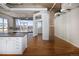 Bright open-concept living room with hardwood floors, exposed ductwork, and a large window showcasing city views at 2020 Arapahoe St # 1130, Denver, CO 80205