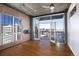 Sunlit living room with hardwood floors, offering expansive views and balcony access at 2020 Arapahoe St # 1130, Denver, CO 80205