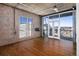 Spacious living room with hardwood floors, exposed ceiling, large windows, and balcony access at 2020 Arapahoe St # 1130, Denver, CO 80205