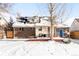 Brick home with deck and fenced backyard in winter at 4191 S Eliot St, Englewood, CO 80110