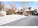 Spacious backyard with shed, deck, and snow covering at 4191 S Eliot St, Englewood, CO 80110