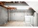 Unfinished basement with laundry hookups and ample storage at 4191 S Eliot St, Englewood, CO 80110