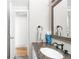 Well-lit bathroom with granite countertop and updated fixtures at 4191 S Eliot St, Englewood, CO 80110