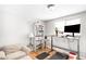 Bright home office features built-in shelving, a standing desk, and comfortable seating at 4191 S Eliot St, Englewood, CO 80110