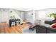 Living room with hardwood floors, gray couch, and entryway at 4191 S Eliot St, Englewood, CO 80110