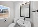 Modern bathroom with black fixtures, sleek vanity, and natural light from a window at 8894 Yellowcress St, Littleton, CO 80125