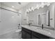 Elegant bathroom with double vanity, quartz countertops, and subway tile shower at 8894 Yellowcress St, Littleton, CO 80125